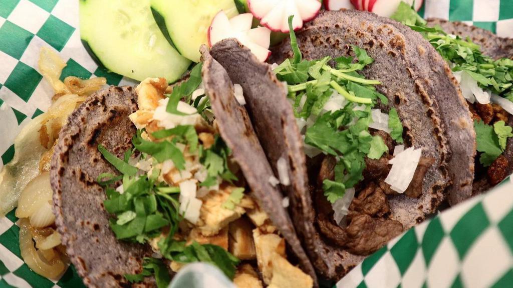 Asada Tacos · Made with handmade blue corn tortillas with meat cilantro, onion, green (mild) or red (spicy) salsa