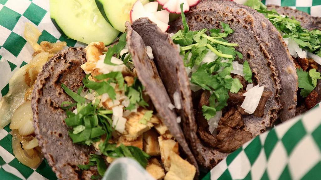 Pastor Tacos · Made with handmade blue corn tortillas with meat cilantro, onion, green (mild) or red (spicy) salsa