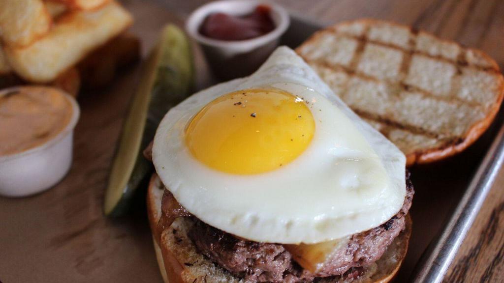 The Peasant Burger · TLP Harris Ranch beef blend, fried egg, grilled onions and house sauce on the side.