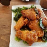 Spicy Chicken Wings · Battered by muay Thai expert then fried and served with house made spicy sauce.