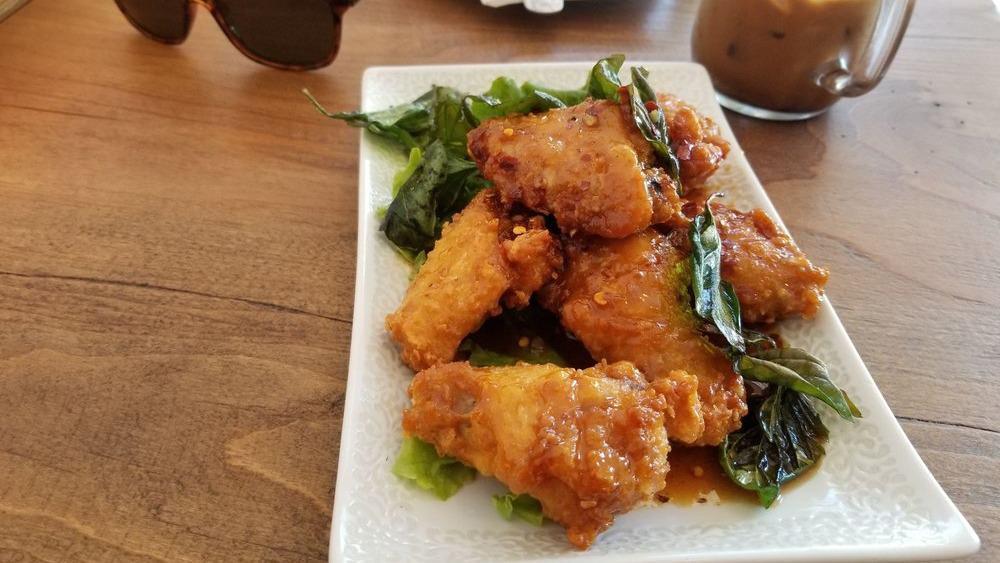 Spicy Chicken Wings · Battered by muay Thai expert then fried and served with house made spicy sauce.
