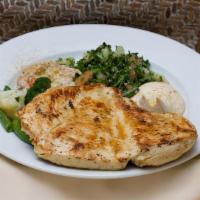 Grilled Chicken Breast · Served with tabbouleh, hummus, moutabal and sautéed vegetables.