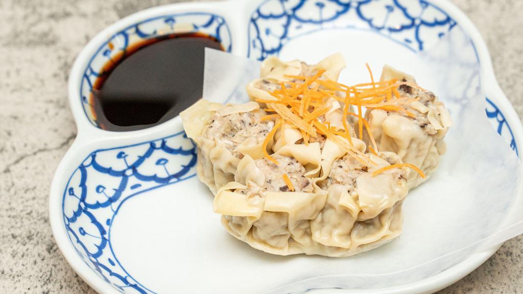 House Dumpling · Kha nom jeep. Ground pork, shrimp, water chestnuts, dried mushroom and onion wrapped in a dumpling skin, steamed and served with a delicious soy bean sauce.
