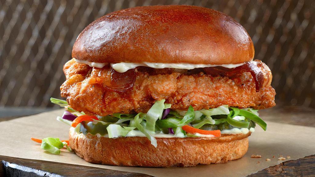 The Fried Slammer · This is our most wanted culprit. Chicken breast, topped with bacon, mayo, fresh cabbage mix and pickles on a soft challah bun. Delivered crispy golden brown.
