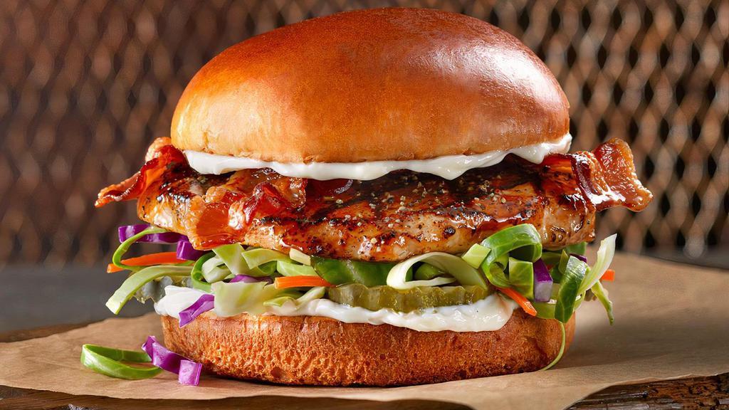 The Grilled Slammer · This is our most wanted culprit. Chicken breast, topped with bacon, mayo, fresh cabbage mix and pickles on a soft challah bun. Delivered seasoned & grilled.