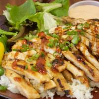Chicken Teriyaki Plate · delicius teriyaki  chicken over steam rice, green salad onions  and sesame seeds on top