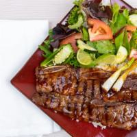 Short Rib Plate · 8 oz  of delicius short ribs marinade on teriyaki sauce over steam rice ,green salad, scalli...