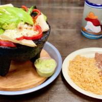 Molcajete Beef, Chicken And Shrimp · Combination of meats served with rice, beans, guacamole, sour cream and our delicious molcaj...
