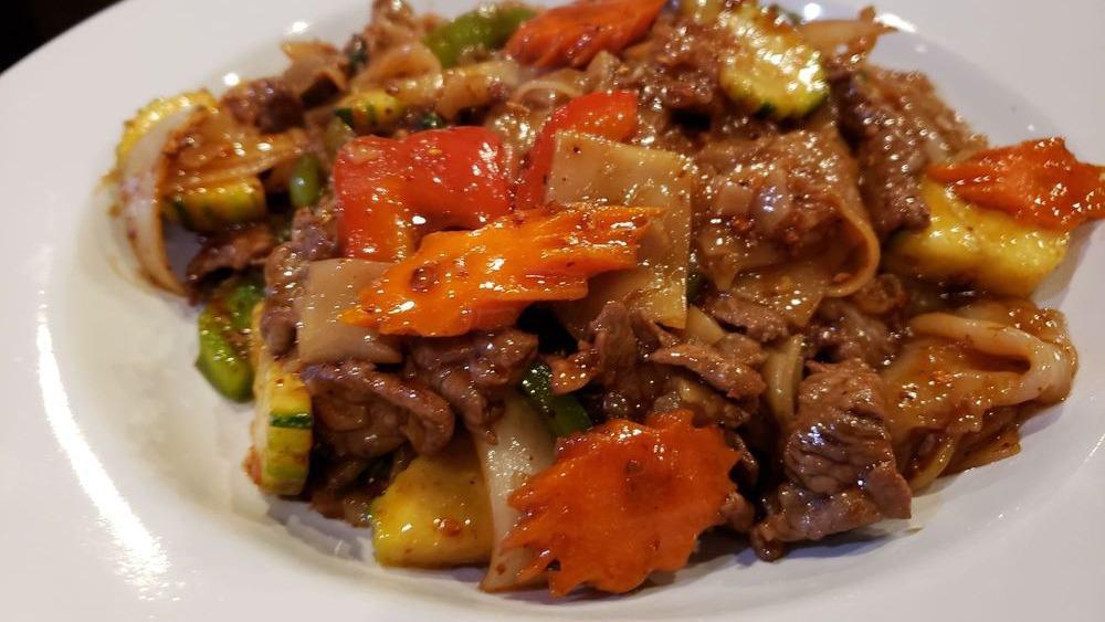 Pad Kee Mao (Drunken Noodle) · Stir-fried flat noodles, garlic, chili, sweet basil, bell peppers, tomatoes, onions and carrots with our special house sauce.