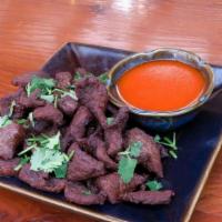 Heavenly Beef · Seasoned fried beef, cilantro, sriracha sauce.