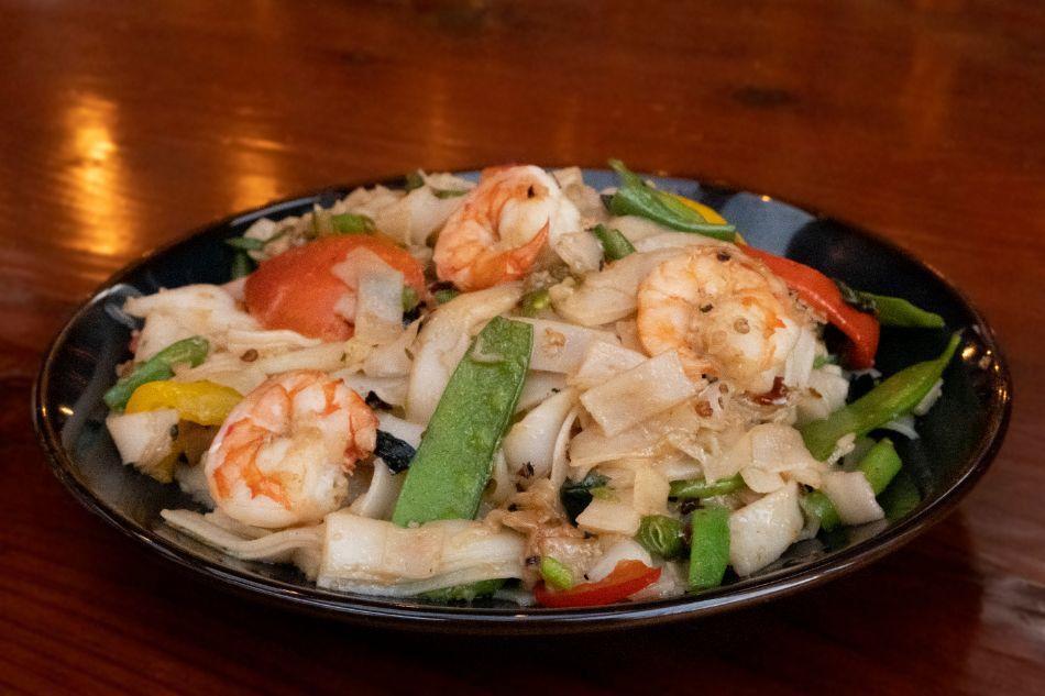 Drunken Noodles (Pad Kee Mao) · Wide rice noodles, garlic, Thai basil, green beans, bell peppers, snow peas, tomatoes.