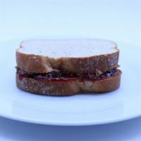 Peanut Butter And Strawberry Jelly Sandwich · Crunchy Peanut butter and Strawberry Jelly on Golden Wheat
