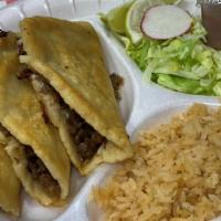Doradita · 3 handmade crispy tortillas, cheese, and your choice of meat, rice, lettuce, sour cream, and...