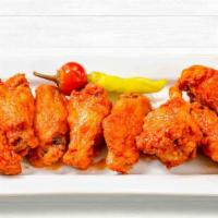 Buffalo Wings · Chicken wings on the bone, tossed in a traditional buffalo sauce, and served with a side of ...