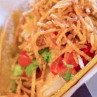 Garlic Shrimp Taco · Mango pico de gallo, avocado, and a crispy potato nest.