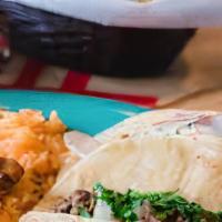 Carne Asada Tacos · Two tacos. Salsa verde, onion, and cilantro. Served with rice, beans and cheese.