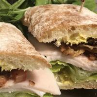 Breakfast Sandwich · Scrambled eggs, Mozzarella, choice of ham or bacon on ciabatta bread.