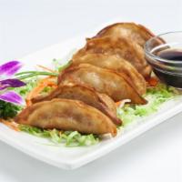 Gyoza (Pot Sticker) · Fried dumplings filled with ground chicken, cabbage and scallion served with sweet soy sauce...
