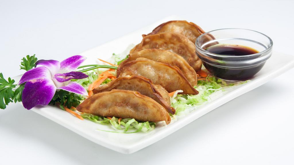 Gyoza (Pot Sticker) · Fried dumplings filled with ground chicken, cabbage and scallion served with sweet soy sauce. (6pcs).