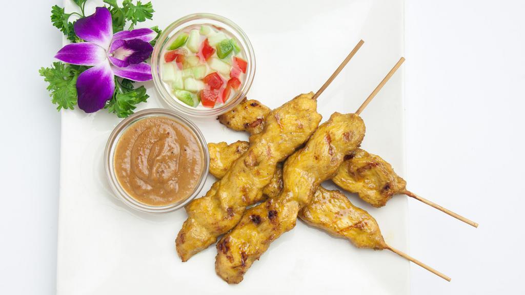 Satay Chicken · Skewered slice of marinated chicken served with peanut sauce and cucumber vinaigrette. (4pcs).