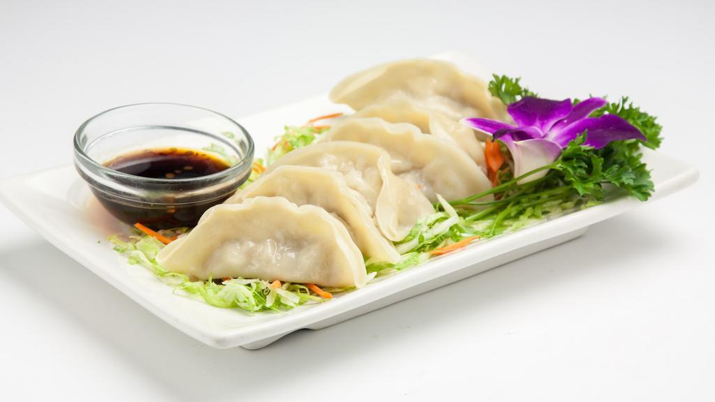 Steamed Dumplings · Dumplings filled with ground chicken, cabbage and scallion served with sweet soy sauce. (6pcs.).
