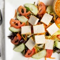 House Salad · Spring mix salad, tomato, cucumber, carrot and tofu served with peanut dressing.