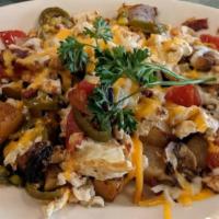 Spicy California Skillet · Our home-style potatoes topped with bacon, mushrooms, tomatoes, jalapeños, scrambled eggs an...