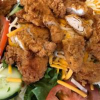Chicken Strip Salad · Our tender fried chicken strips, hard-boiled eggs, bacon, shredded cheese and tomato slices,...