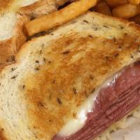 Reuben Sandwich · Tender, lean corned beef topped with sauerkraut and melted jack cheese. Served on grilled ry...