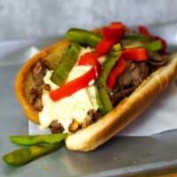 Grilled Pepper Cheesesteak · Philly cheesesteak loaded with grilled steak, melted cheese, and grilled bell peppers on a t...