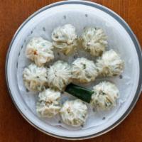 Shrimp & Pork Dumplings · 새우만두 . Ten pieces of steamed dumplings shrimp, pork, and vegetables.