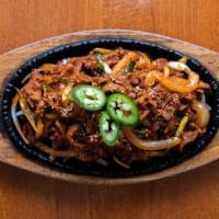 Pork Bulgogi · 돼지불고기. Spicy and deliciously marinated pork barbeque with grilled onions served on a sizzlin...