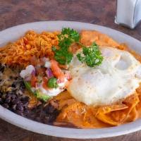 Huevos Rancheros Breakfast · Two eggs topped with ranchero sauce served over fried corn tortillas with black beans, salsa...