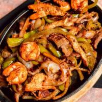Shrimp Fajitas · Sizzling shrimp cooked with delicious sauce, bell pepper and onion, served with guacamole so...