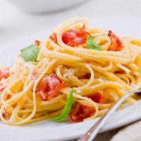 Spaghetti Carbonara · Crispy bacon, sweet peas, mushrooms, and choice of sauce on spaghetti