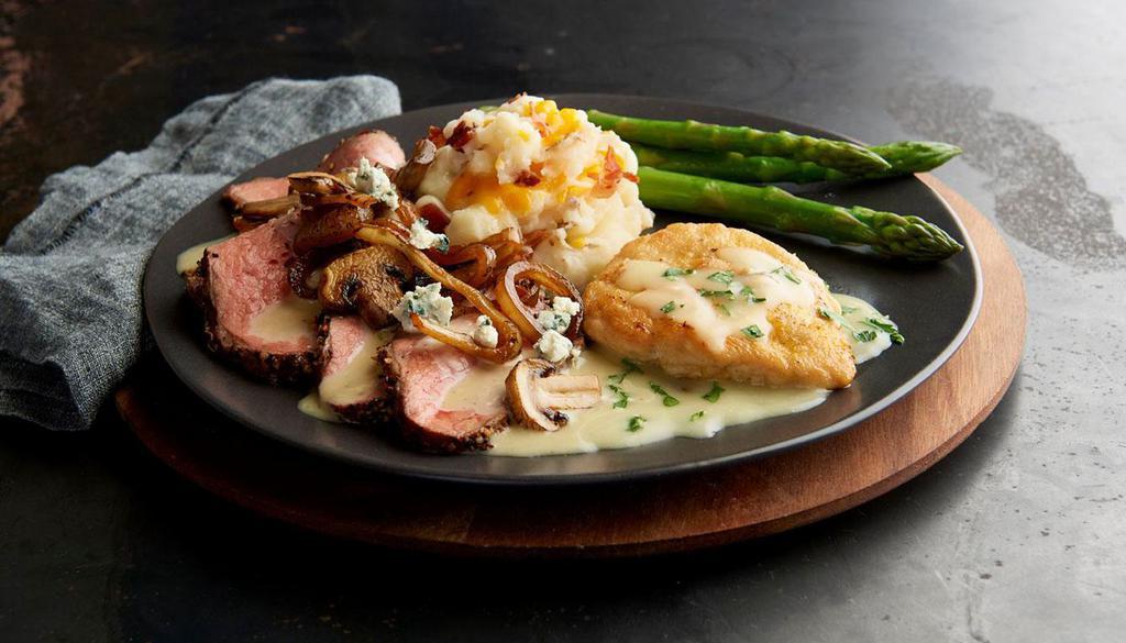 The Tri-Tip Prospector · Slow-roasted Tri-Tip and seared chicken smothered in a caramelized onion and mushroom bleu cheese sauce. Served with choice of 2 sides.