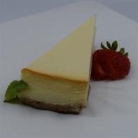 Classic Ny Cheesecake · Creamy NY style cheesecake served with raspberry and chocolate sauce.