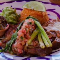 Famous Carnitas · made with prime pork, salsa quemada, rice, beans, guacamole, pico de gallo and tortillas.
