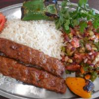 Koobidah Kebab Plate · Seasoned mix of ground meat/lamb grilled on open flame. Comes with grilled tomato, spicy pep...