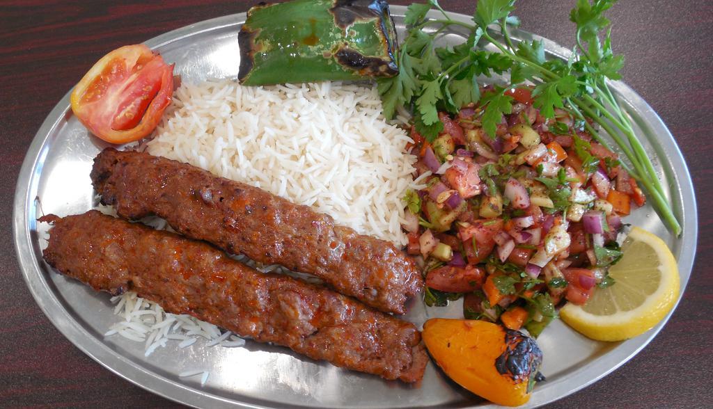 Koobidah Kebab Plate · Seasoned mix of ground meat/lamb grilled on open flame. Comes with grilled tomato, spicy pepper, salad, rice, hummus, tzatziki, butter and a half pita bread.