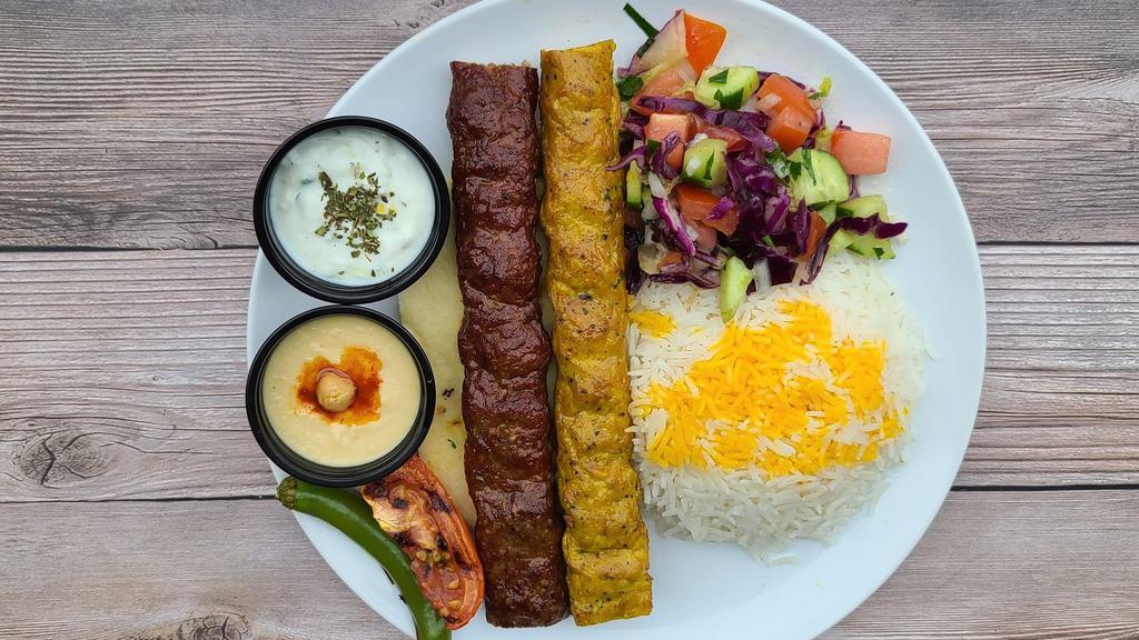 Mix Koobideh Plate · Seasoned mix of ground meat/lamb and ground chicken grilled on open flame. Comes with grilled tomato, spicy pepper, salad, rice, hummus, tzatziki, butter and a half pita bread.