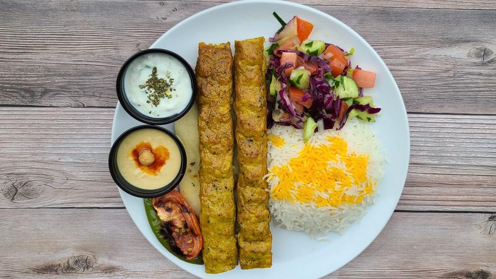 Chicken Koobideh Kebab · Seasoned mix of ground chicken grilled on open flame. Comes with grilled tomato, spicy pepper, salad, rice, hummus, tzatziki, butter and a half pita bread.
