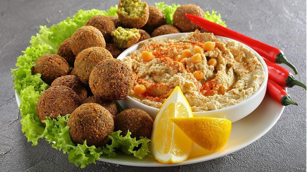 Falafel Plate (Updated-New!) · Vegetarian patties made from garbanzo beans and spices. Comes with a falafel sauce, hummus, salad and a pita bread.