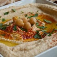 Hummus Plate · Pureed chickpeas topped with paprika and olive oil. Served with a pita bread.