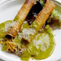 Rolled Taquitos · Crispy rolled chicken or beef taquitos served with beans, roasted tomatillo sauce and topped...
