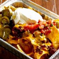 Jimmy Nachos · Zesty ground beef topped with nacho cheese sauce, sour cream, pico de gallo and jalapenos.