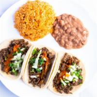Three Taco Combo · Hot sauce, onions, and cilantro. Combo includes three tacos, rice, beans, and a medium drink.