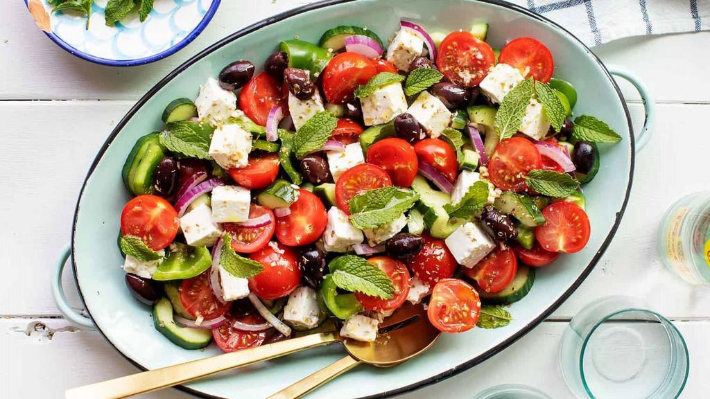 Greek Salad · Mixed greens served with cucumber, onions, tomato, olives, and feta cheese.