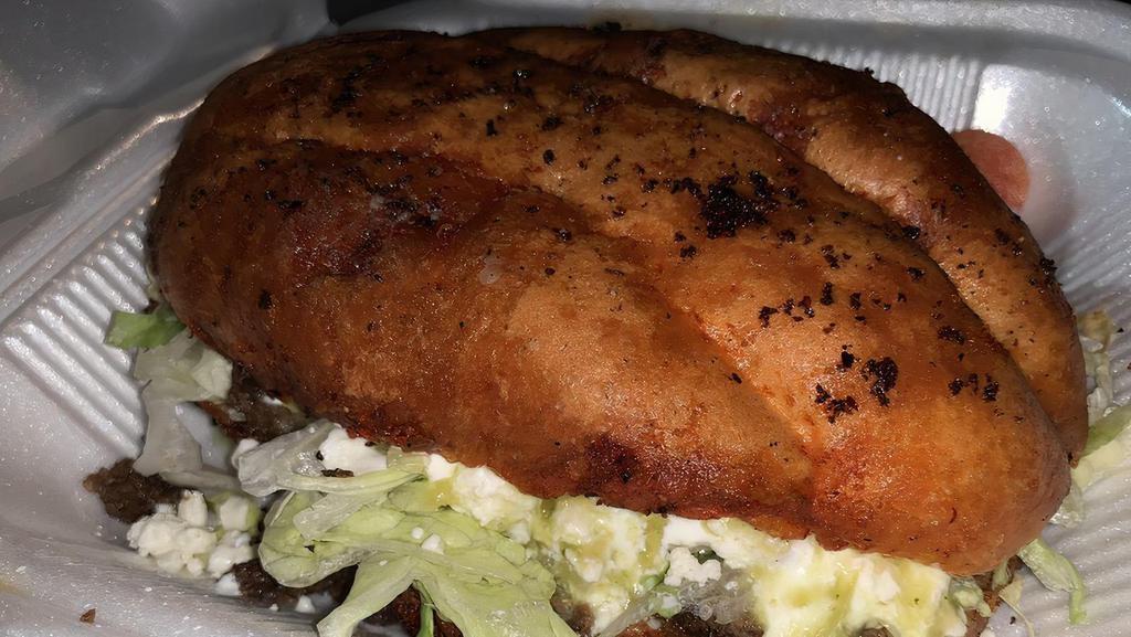 Pambazo · Fresh white Torta bread dipped in Doña Mari’s special Guajillo sauce! Medium Fried and topped off w/choice of meat, lettuce, queso fresco, sour cream, cotija powdered cheese, slice of onion and our special salsa verde with a jalapeno on the side.