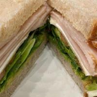 Smoked Turkey Sandwich · Smoked turkey, avocado, tomato, artisan cheese, house mayo and mixed greens.